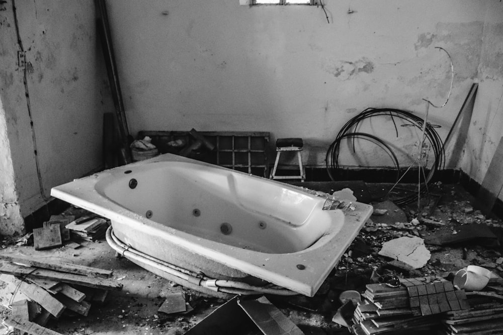 white bathtub inside room with scattered woods