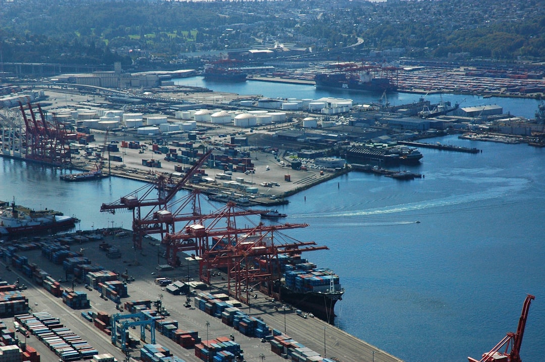 aerial photography of harbor, Unloading a shipment, 4 cranes, stacks of containers, tug boat, small boat, wakes, man-made island, shadow, sunlight, winter, Universal Responsibility in a Matrixed Economic World, Port of Seattle, West Seattle, Washington, USA<p></figure>drop a penny if you wish https://paypal.me/1drlane</p><p>wonderlane@gmail.com