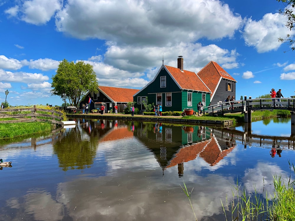 green house beside body of water view during daytime