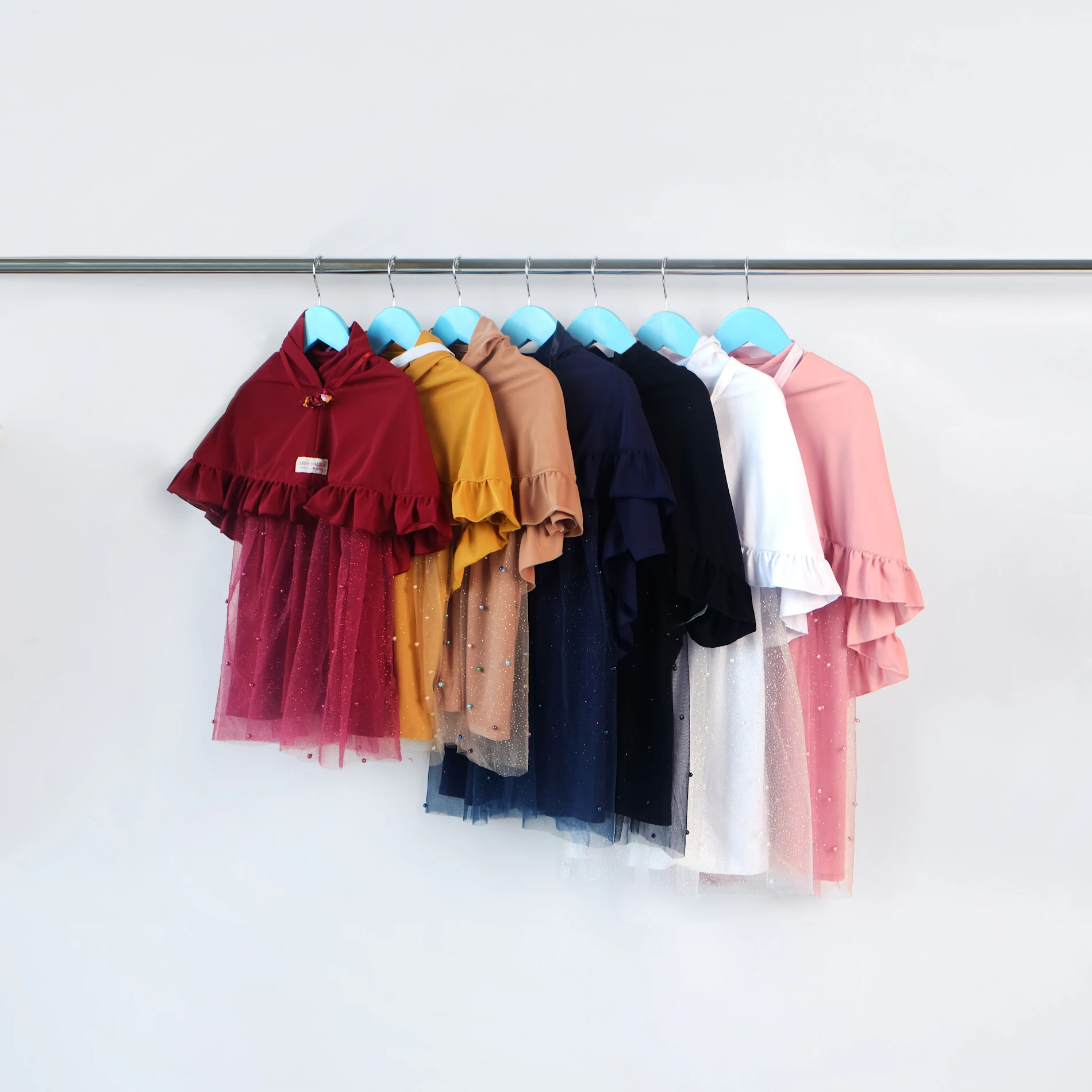 Children's clothing in assorted colours on a rail
