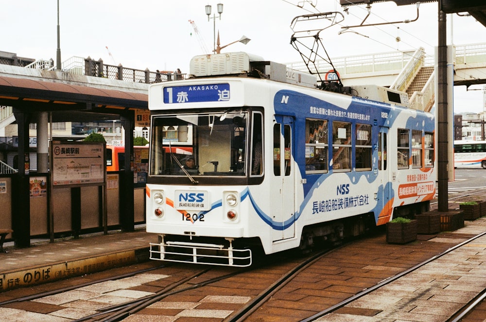 white and blue train under white sky