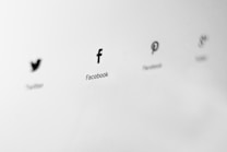 Logos of social media platforms are displayed in a minimalist style on a light gray background. The logos are aligned horizontally, and each is labeled with the name of the corresponding platform.