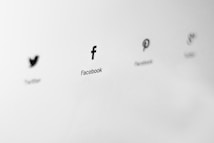 Logos of social media platforms are displayed in a minimalist style on a light gray background. The logos are aligned horizontally, and each is labeled with the name of the corresponding platform.
