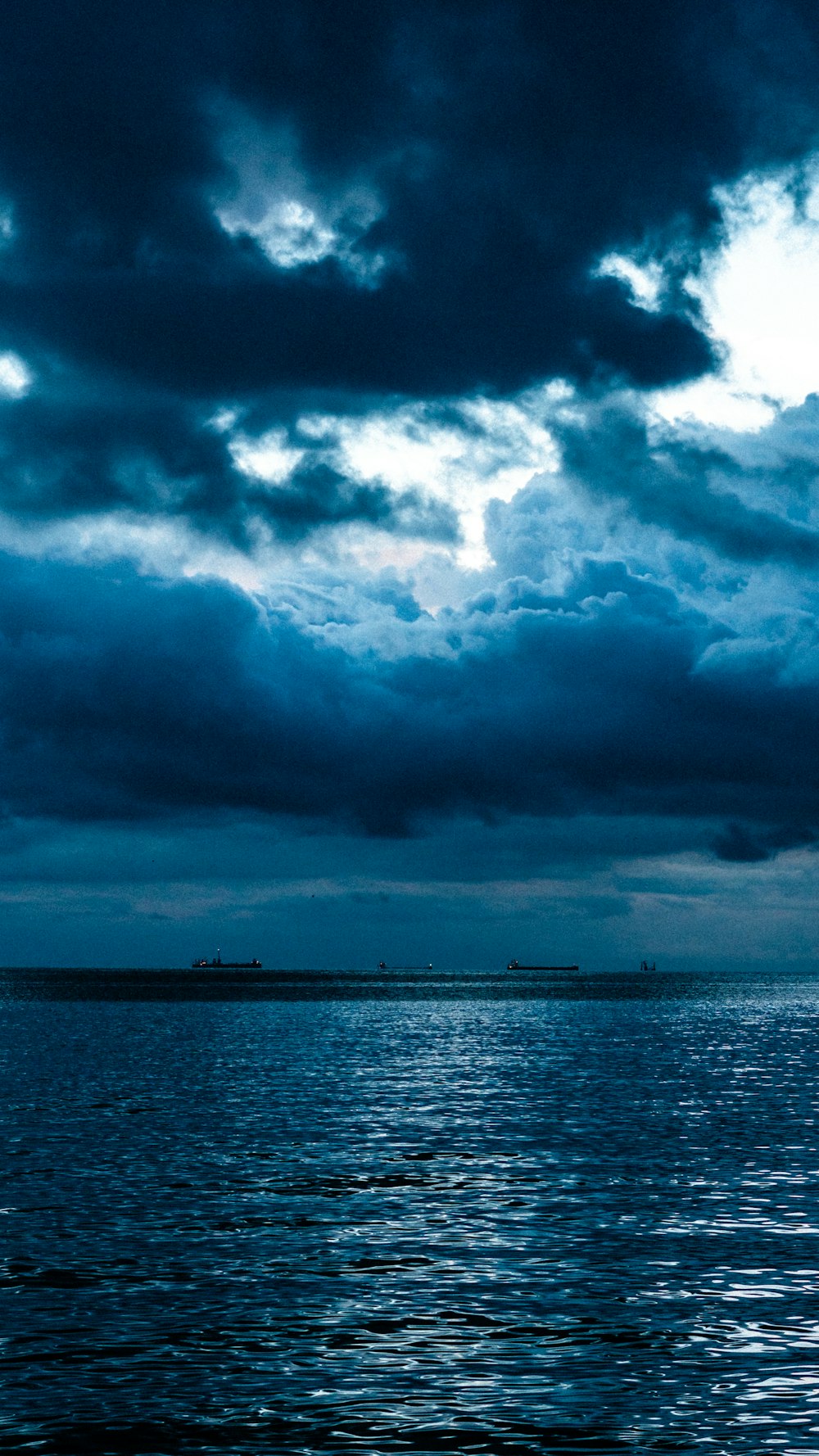 a large body of water under a cloudy sky