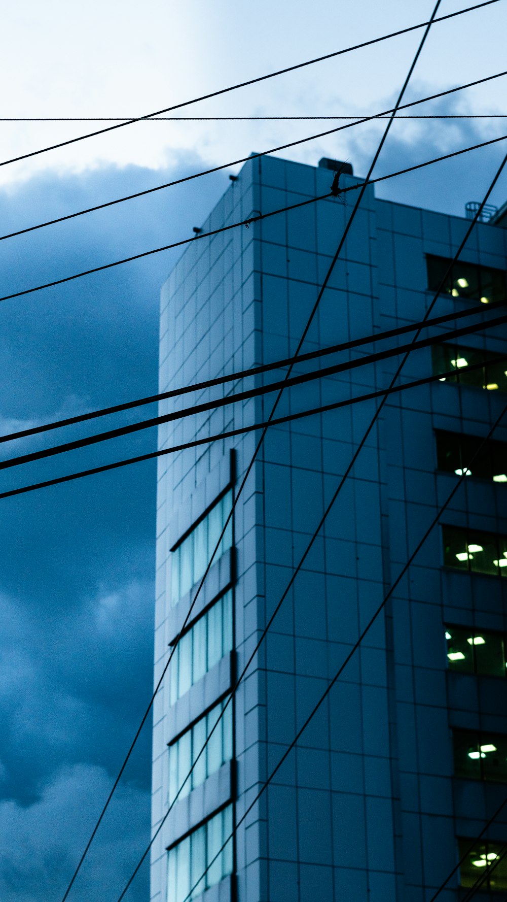 gray concrete building under cloudy sky during daytime