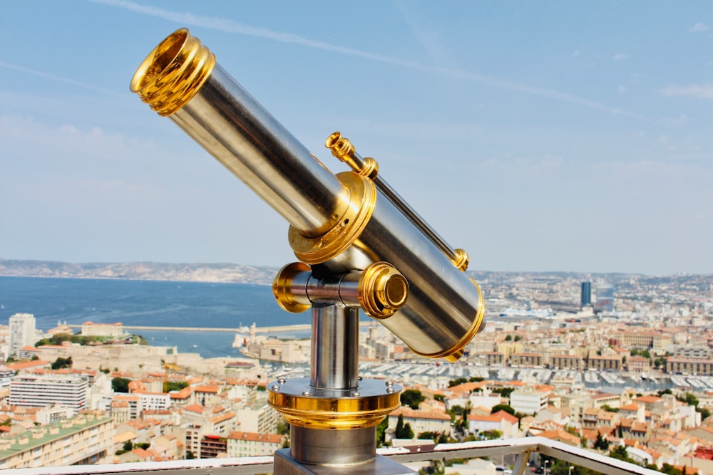 gray and gold-colored telescope at daytime