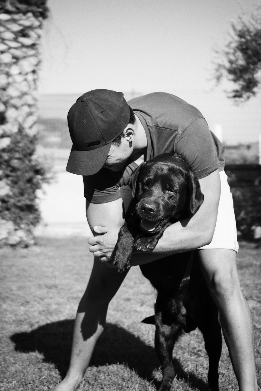 man hugging dog