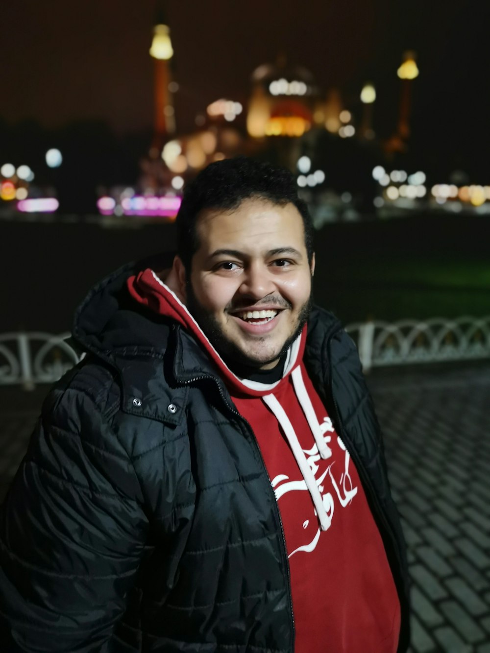 smiling man wearing black leather jacket