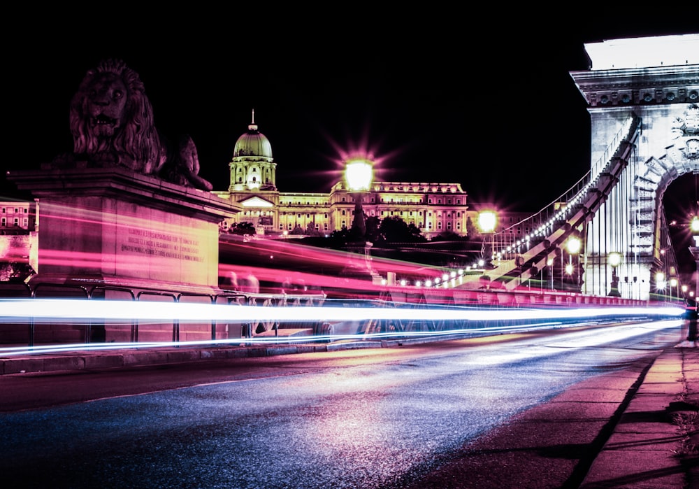 time lapse photo of cars passing by bridge during nighttime