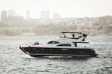 white and black boat on body of water at daytime