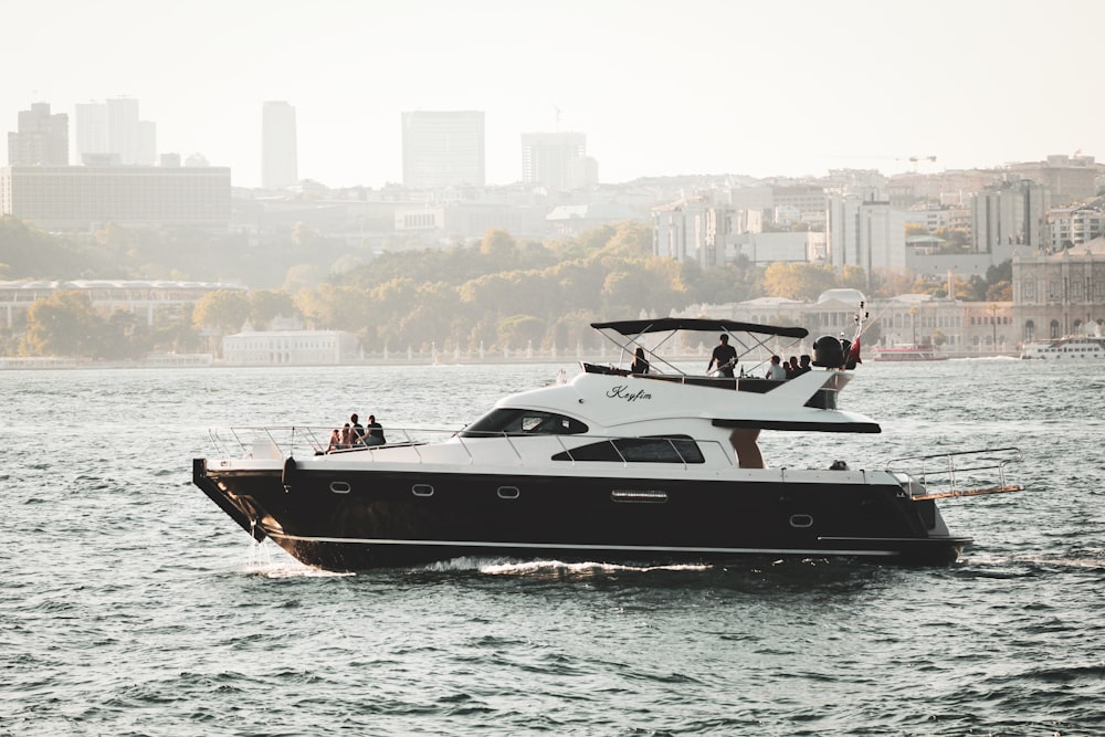 white and black boat on body of water at daytime