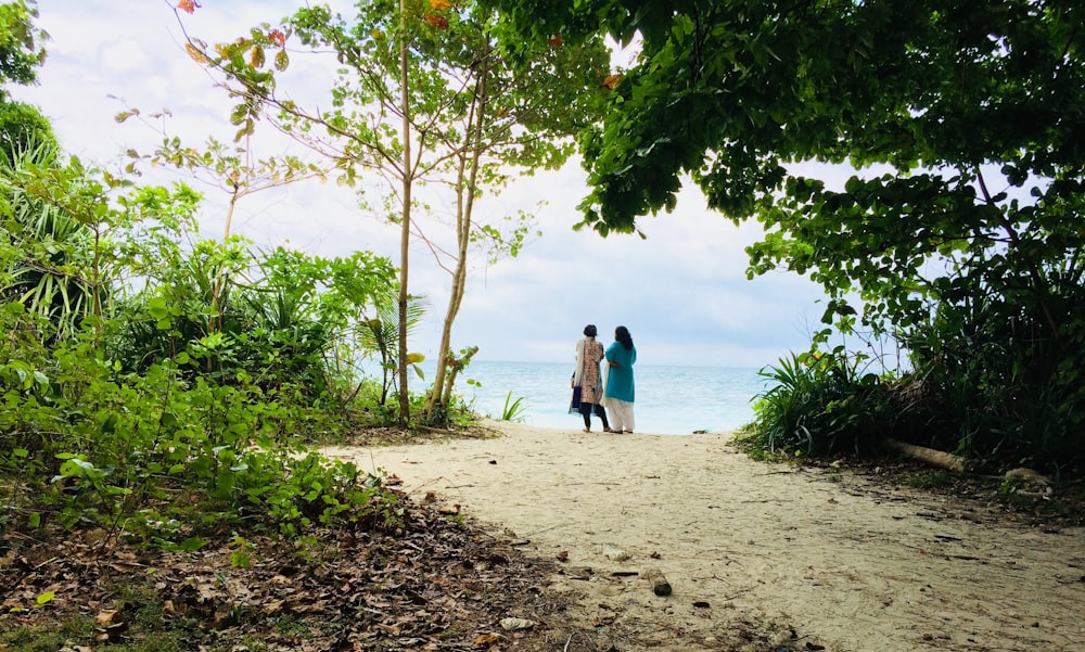 women standing near sea