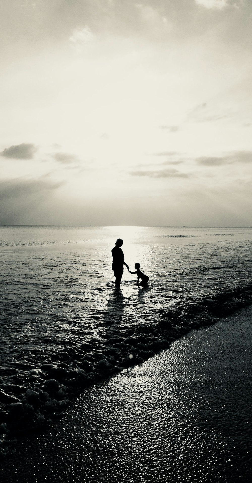 gray-scale photo of woman and child