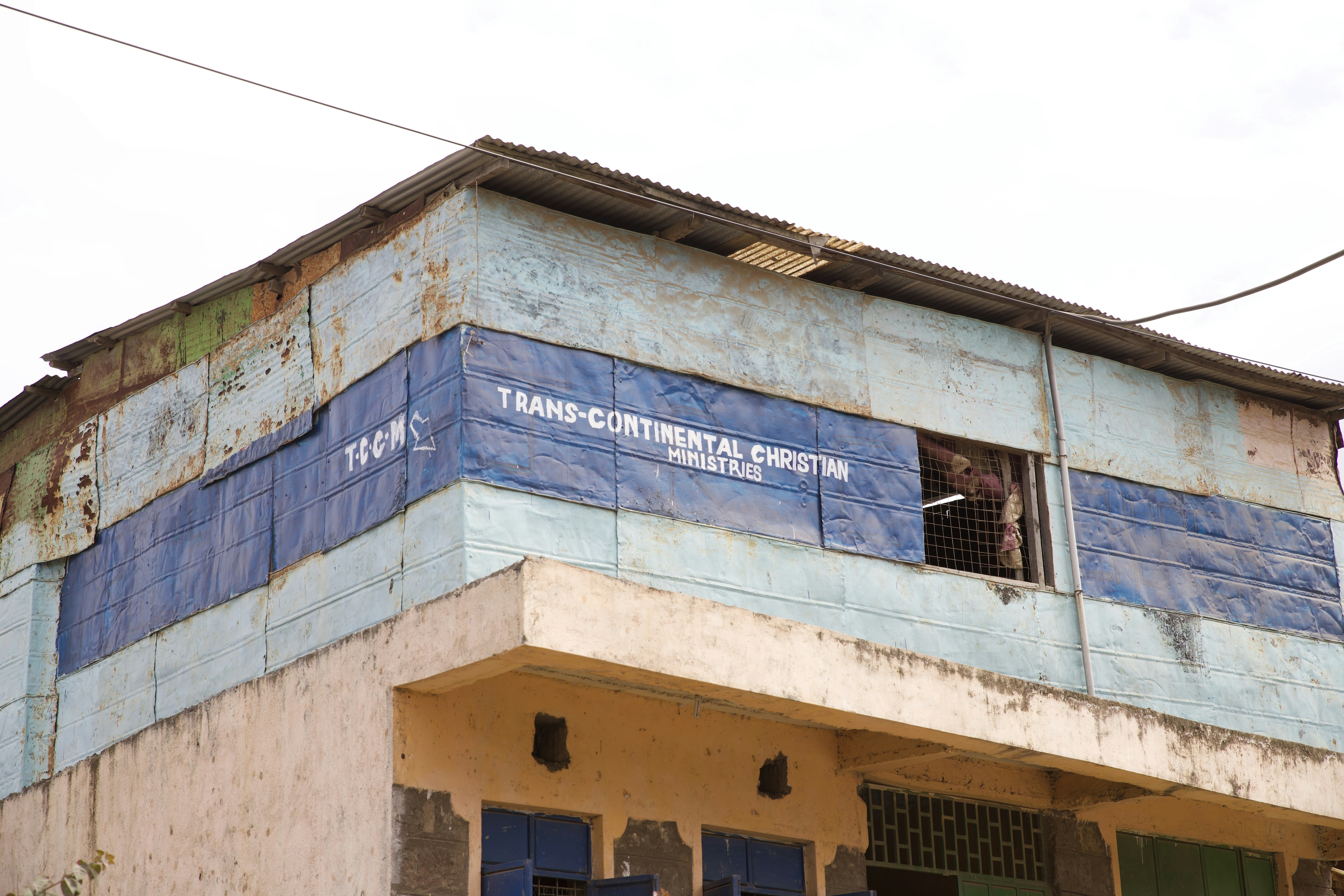 blue tarpaulin with Trans-Continental Christian text