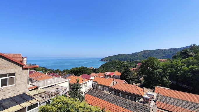A serene coastal view of the Rías Baixas region with houses and greenery.