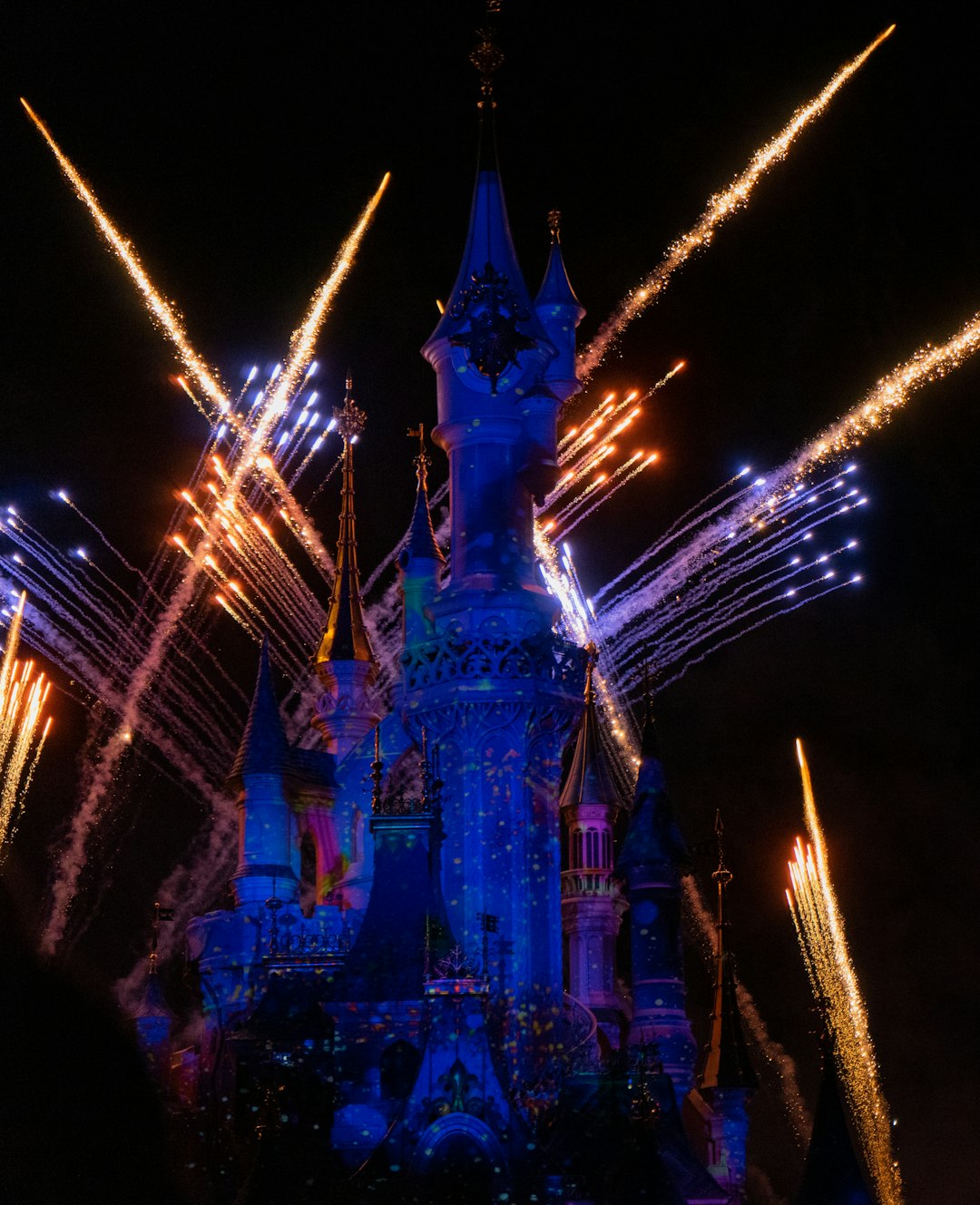 time-lapse photography of fireworks shooting above Disneyland castle