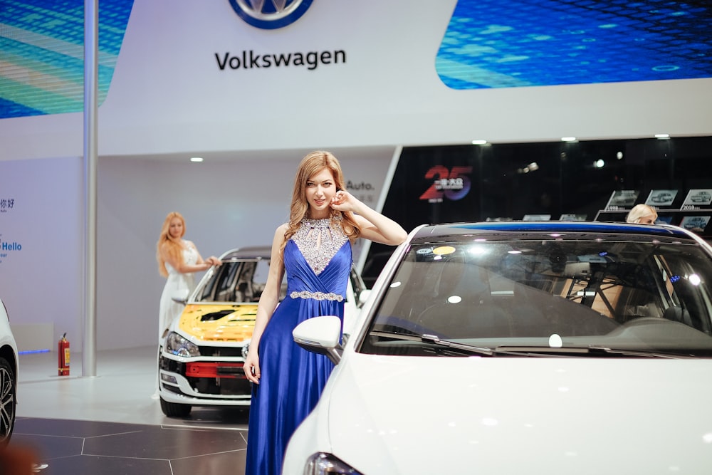 woman leaning an elbow on white vehicle