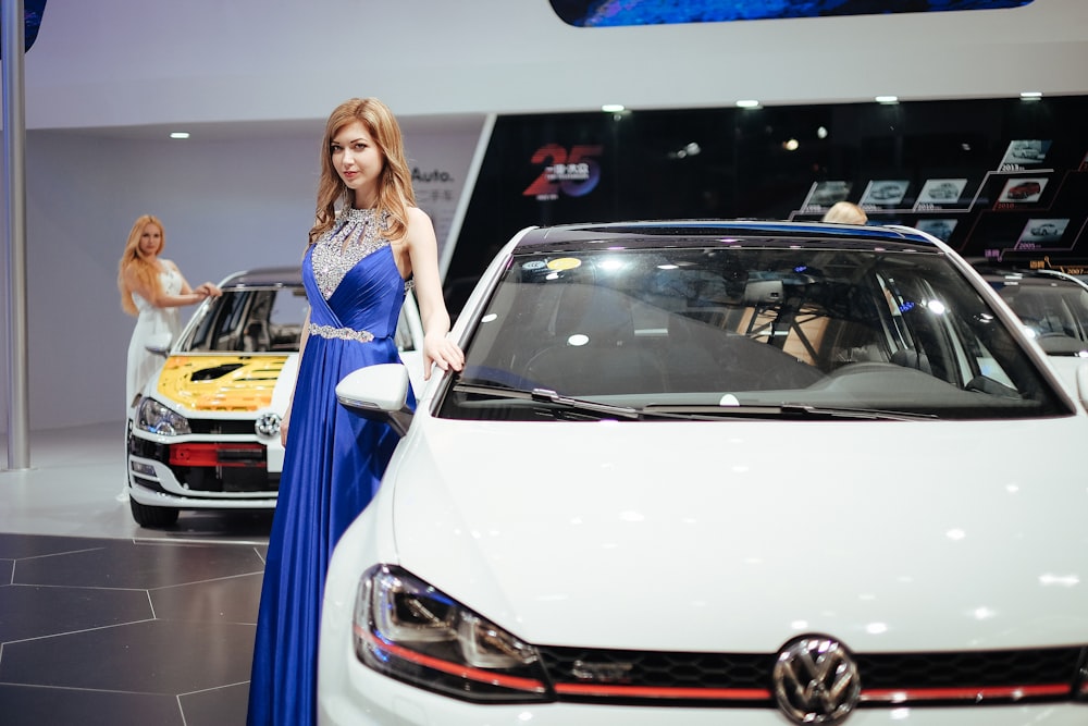 woman standing near Volkswagen car