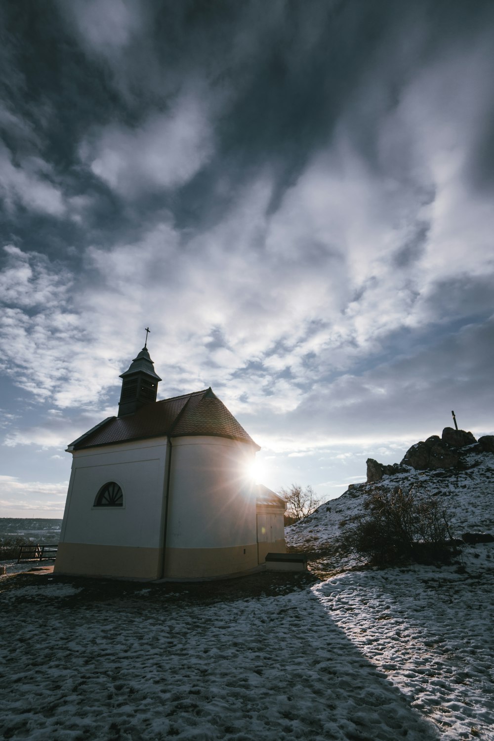 a small white building sitting on top of a sandy beach