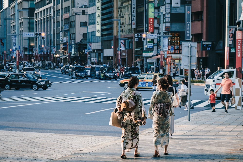 two women wearing traditional Japanese dress walking in street