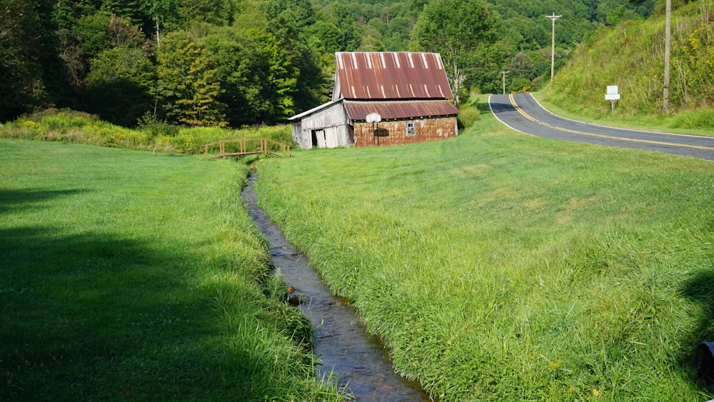 a small stream running through a lush green field
