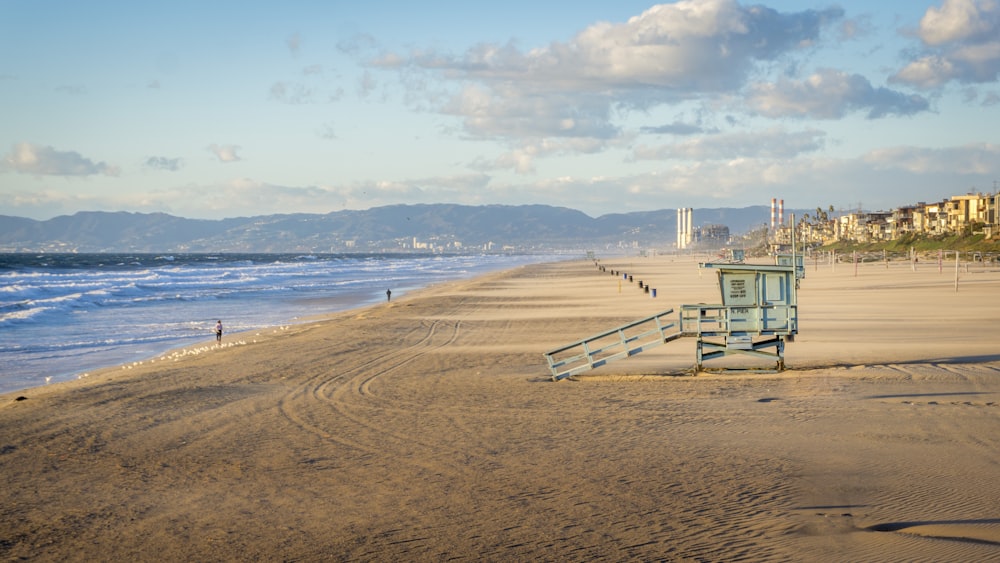 blue wooden watch tower on shore