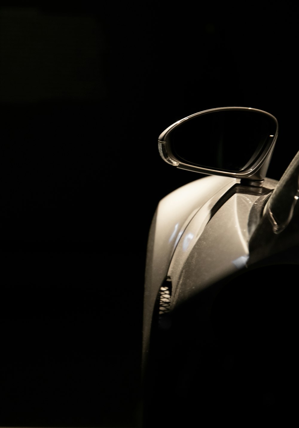 a close up of a car's side mirror in the dark