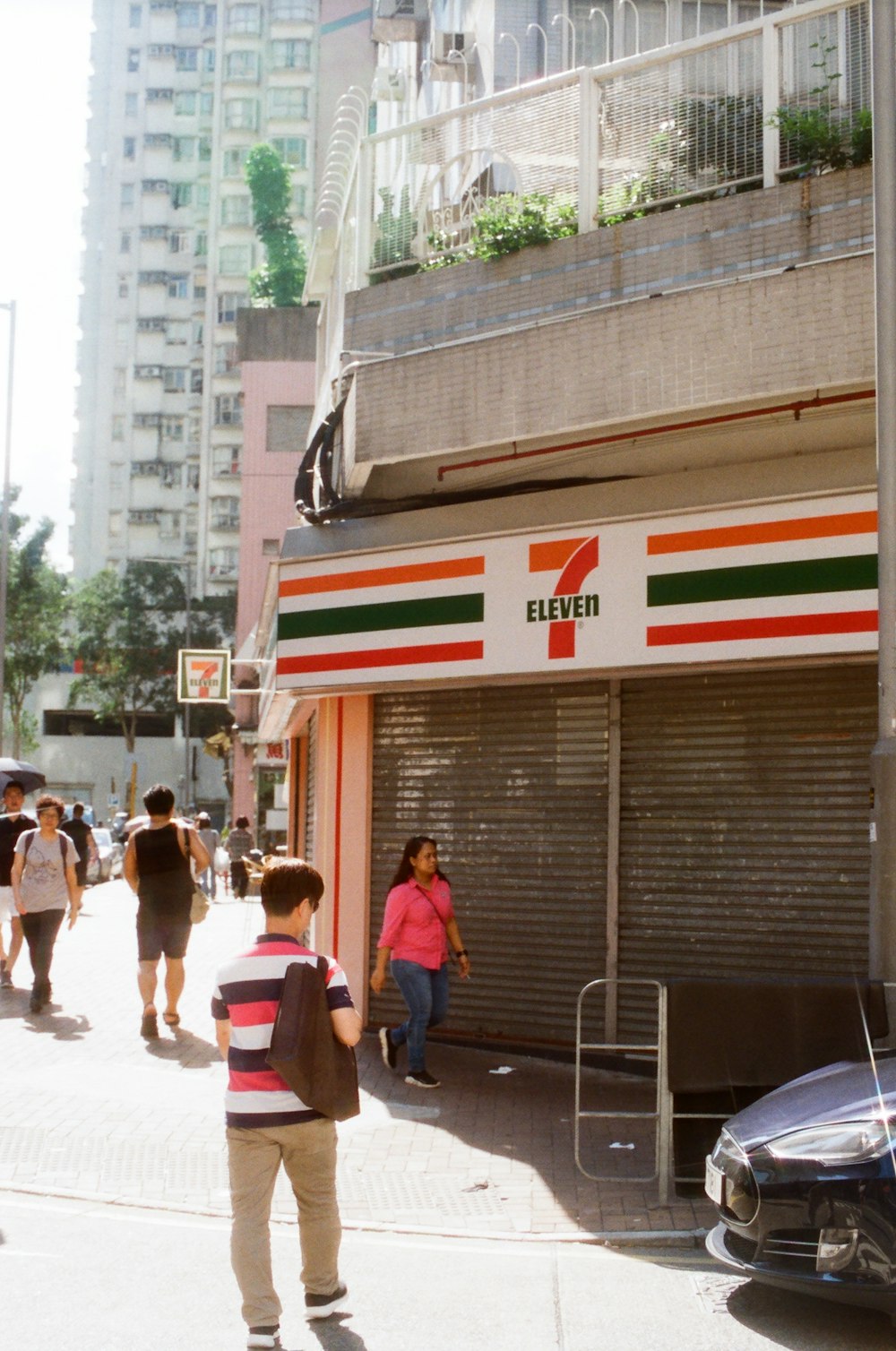 people walking near closed 7-Eleven store