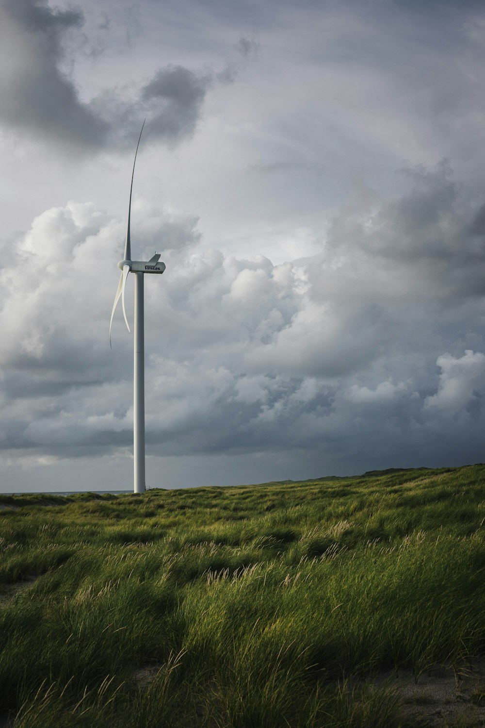 white windmill near grass