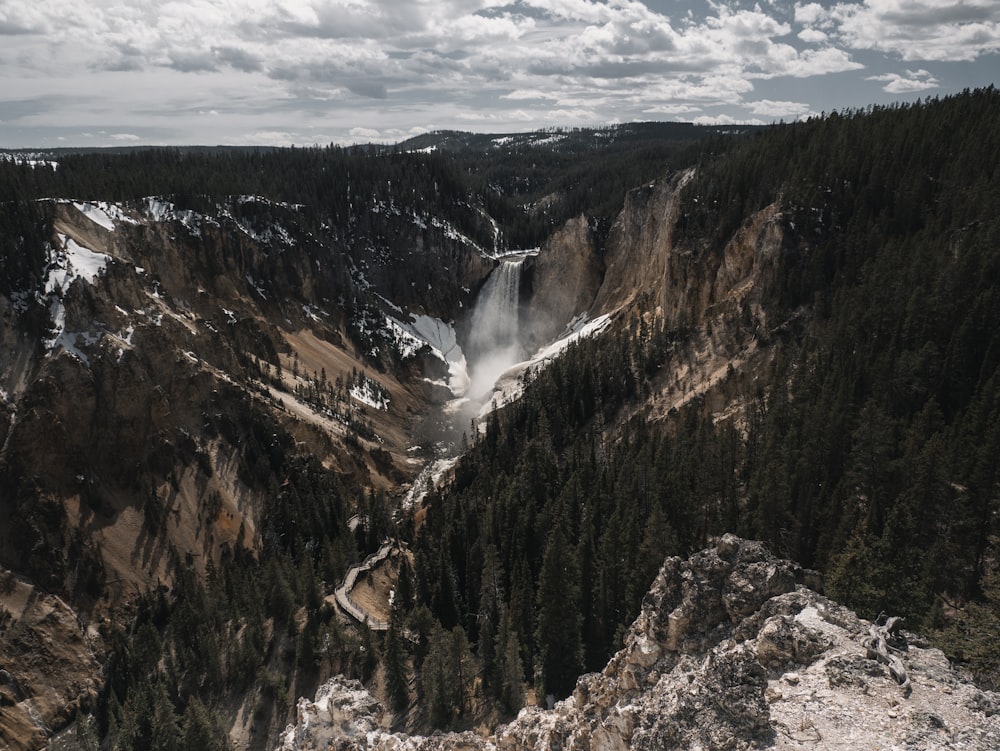 waterfalls viewing mountain under white skies during daytime