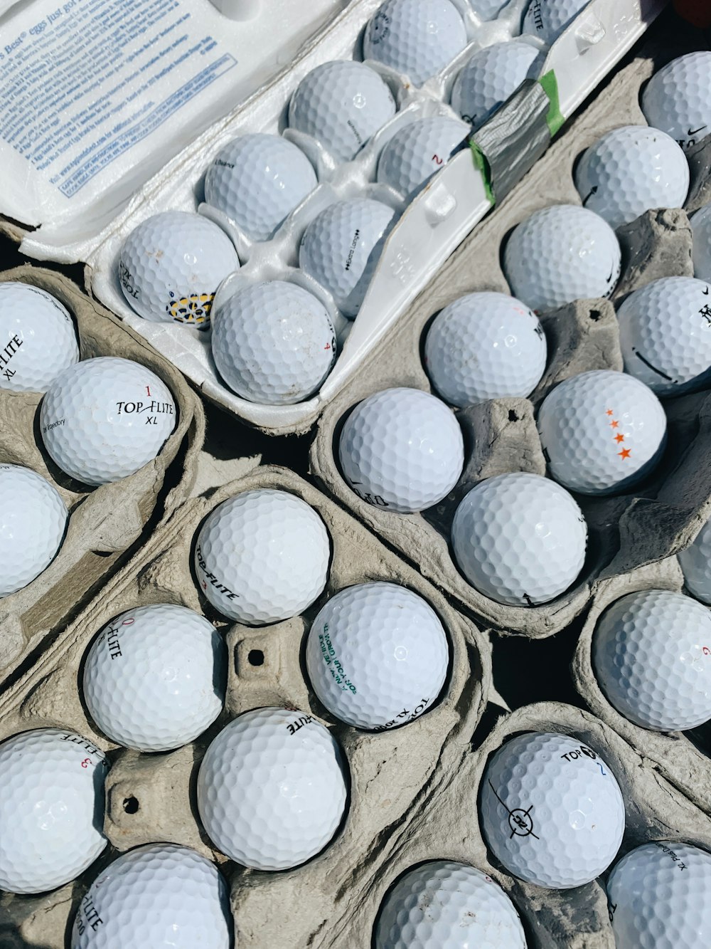 pile of golf ball in box