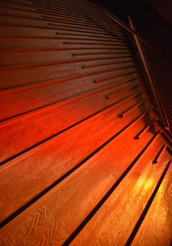 Close-up of wooden slatted wall panel in warm light.
