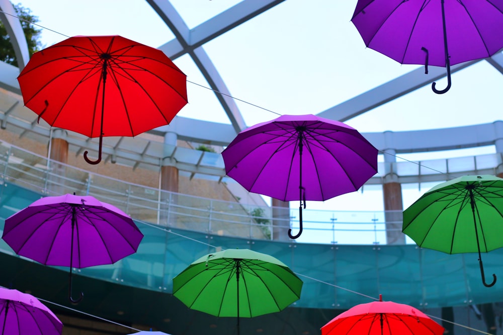 a group of colorful umbrellas hanging from a ceiling