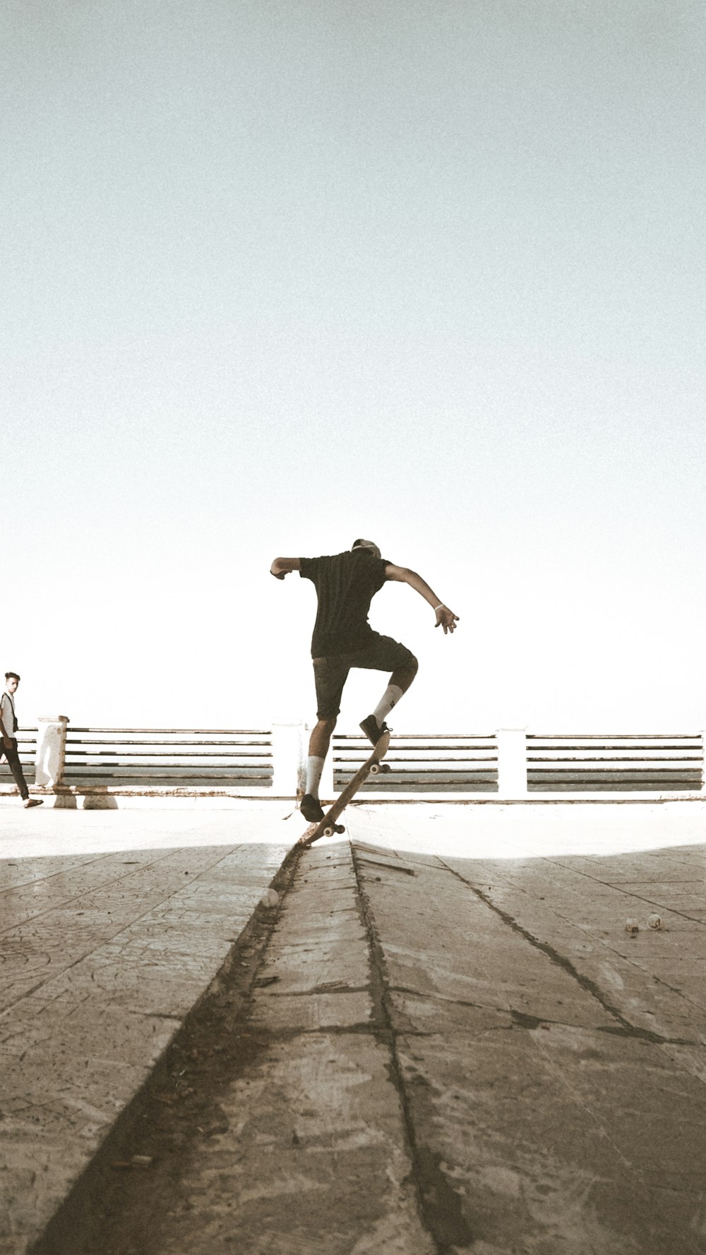 close-up photography of person doing stunt on skateboard