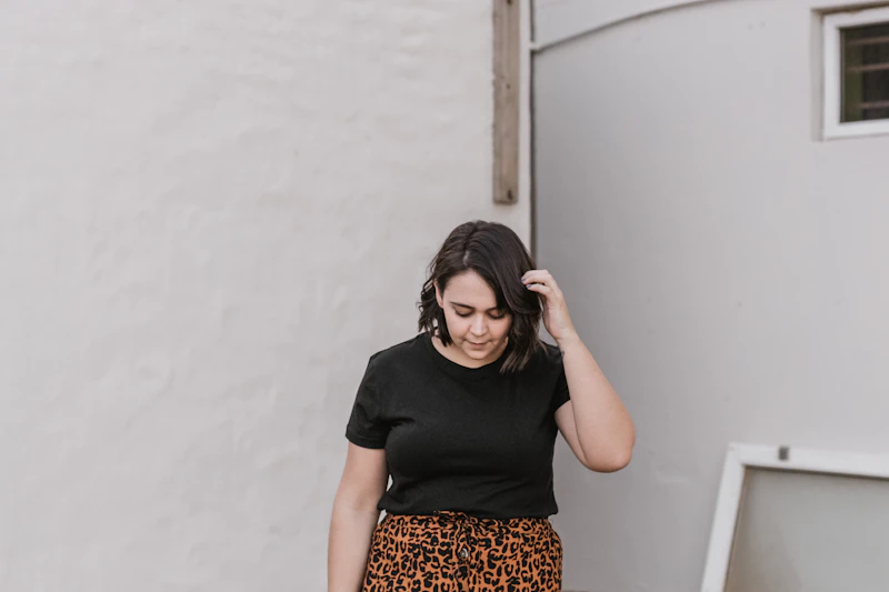 curvy woman holding her hair confidently