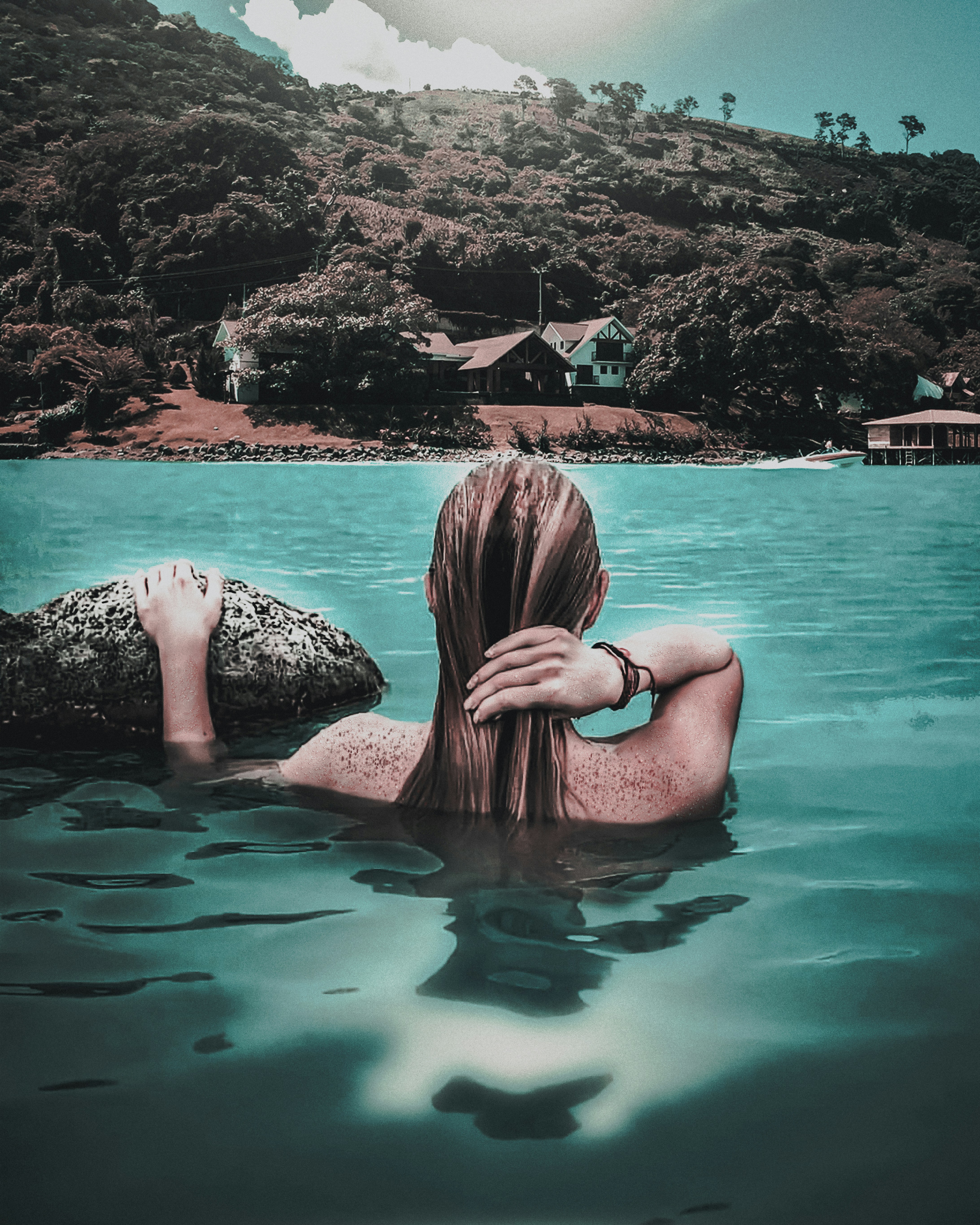a woman swimming in a body of water