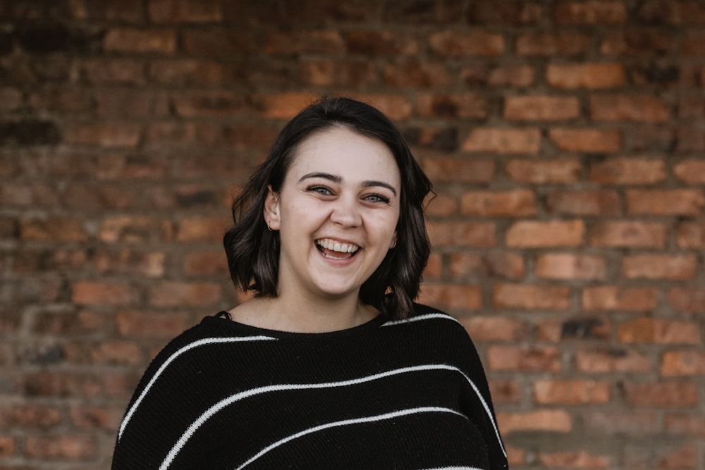 shallow focus photo of woman in black and white striped crew-neck shirt