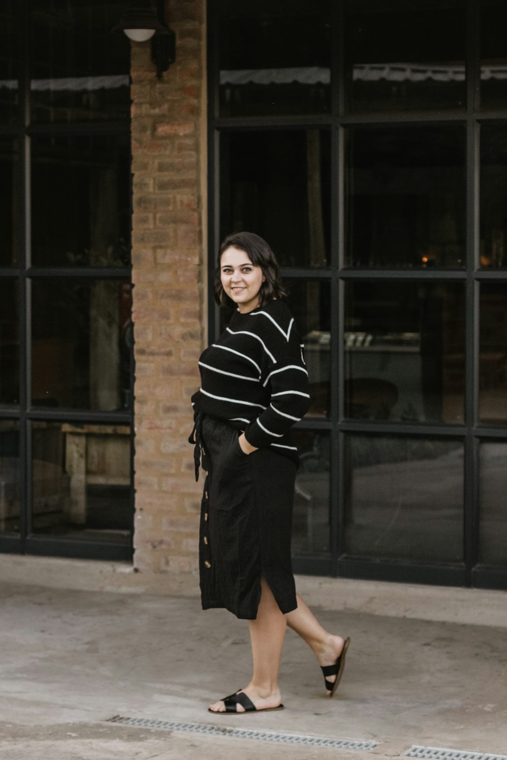 woman wears black and white striped sweatshirt