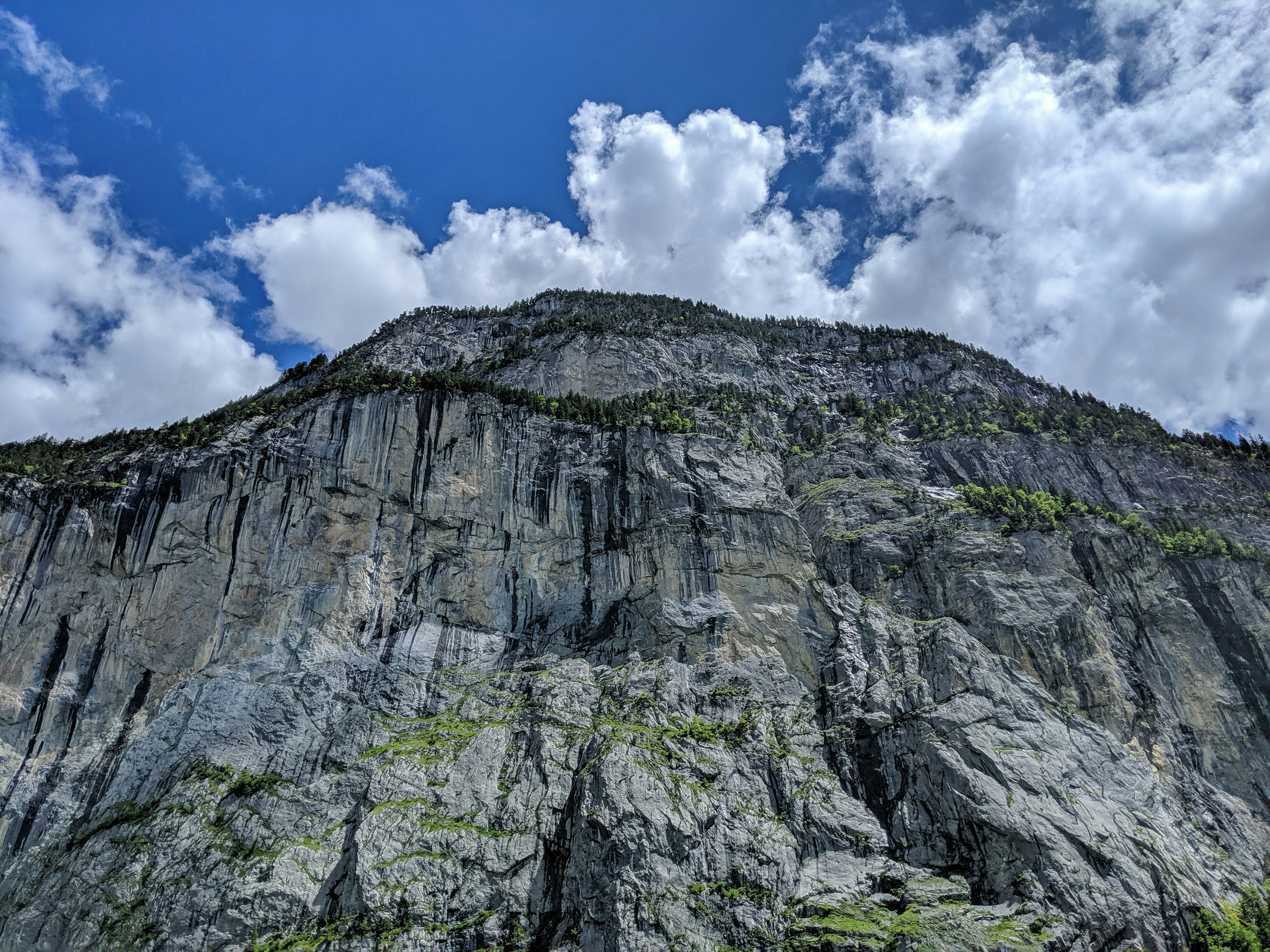 gray and black mountain under blue and white sky at daytim