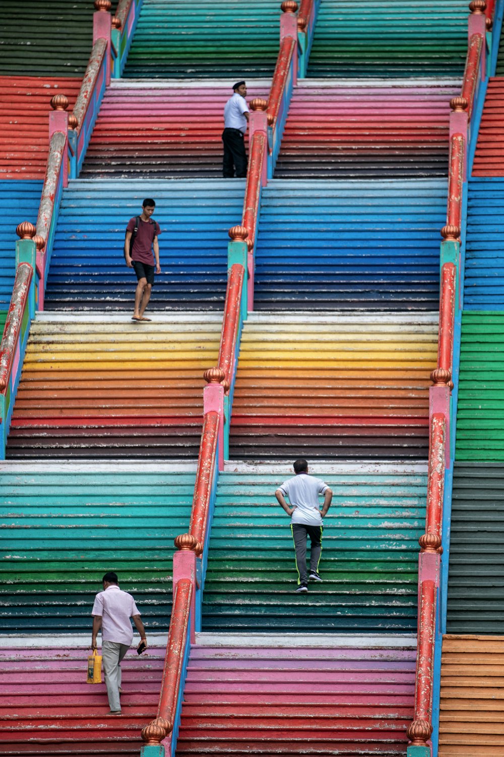 four person walking in stair during daytime