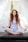woman doing yoga pose sitting on wooden ground