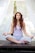 woman doing yoga pose sitting on wooden ground