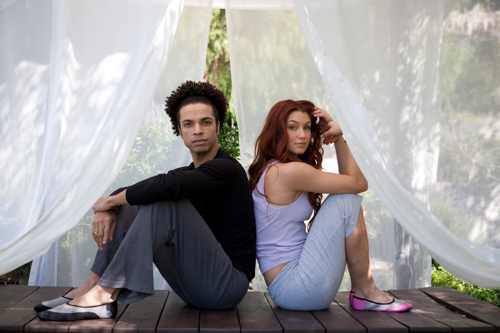 man and woman sitting inside canopy