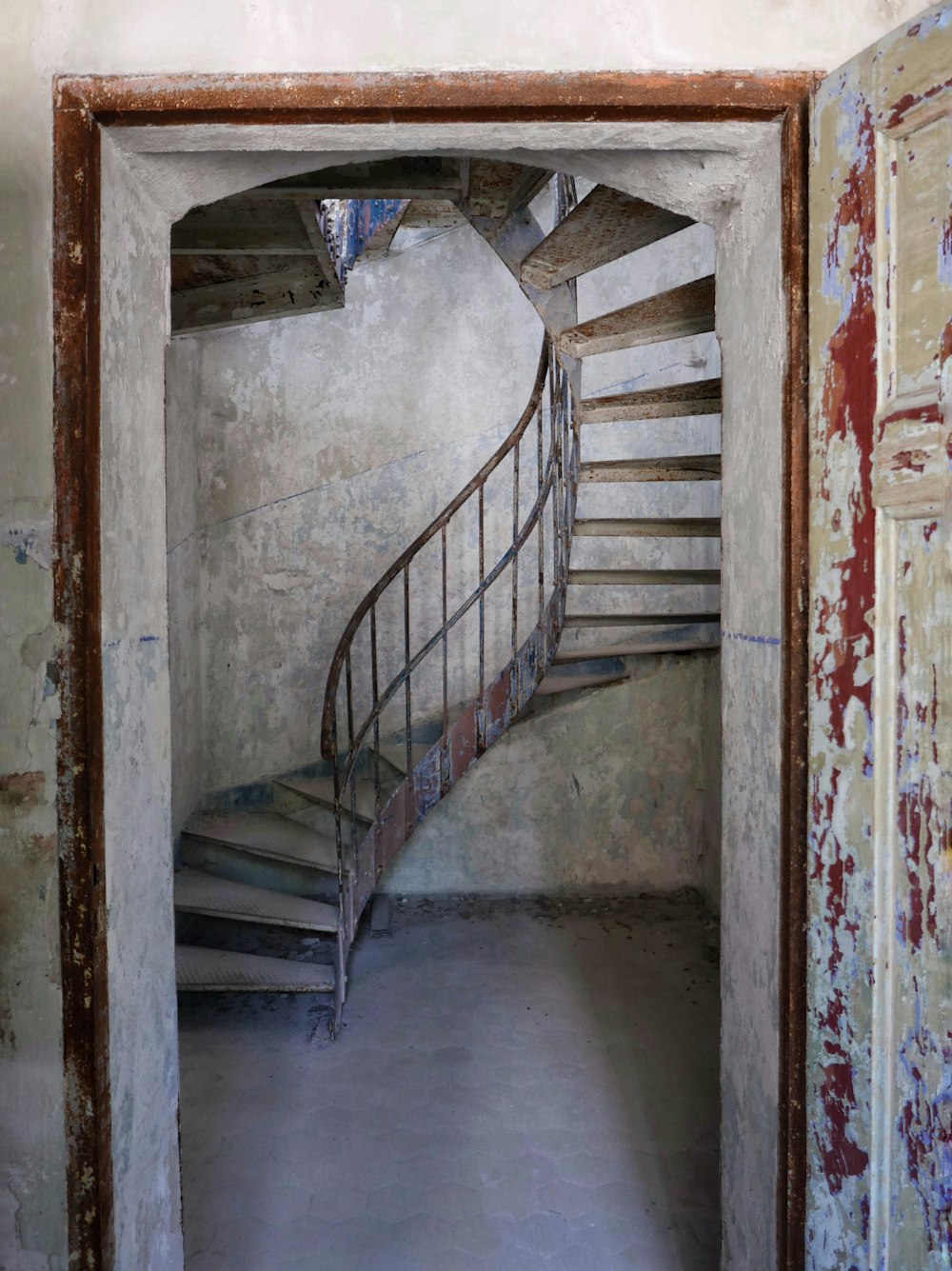 a spiral staircase in an abandoned building