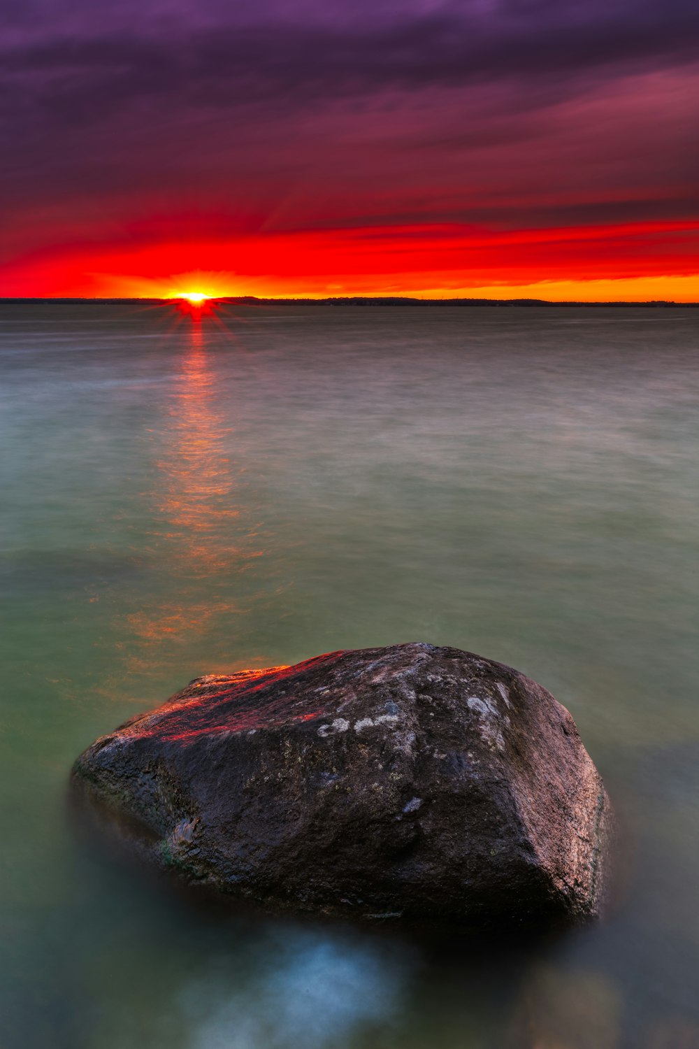 black stone and the beach at sunset