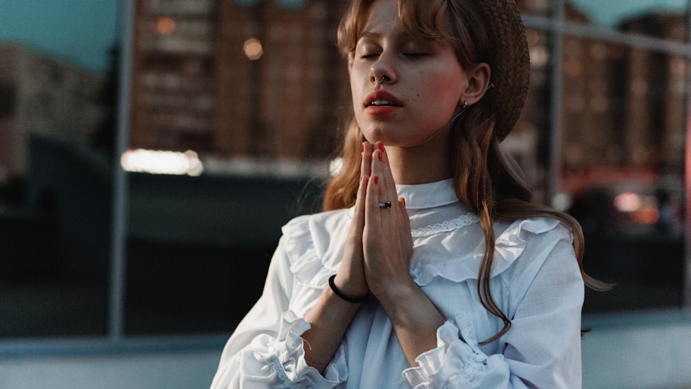 woman in white top praying