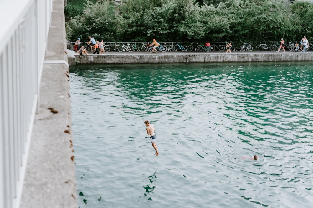 man jumping over water