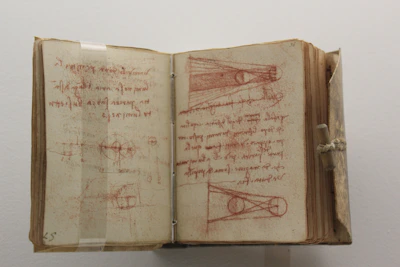Close-up of an open book showing detailed diagrams of early steam engines.