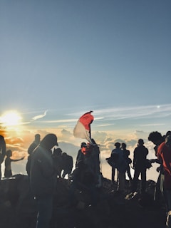 people on cliff during daytime