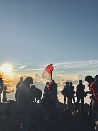 people on cliff during daytime